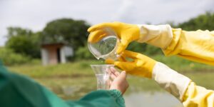 Experts transfer water to flask for tests