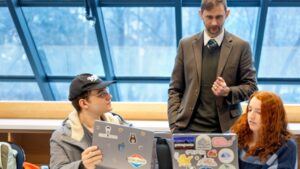 Ault, standing, is working with a leading global advisory and brokerage firm looking for help in answering questions related to drought risks so they can better advise clients.