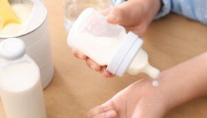 Testing the temperature of baby formula from a bottle