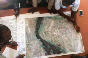 James Campbell, founder and lead of RFMS, and community leaders identify survey locations in Malawi and plan follow-up work (photo by J. Upton).