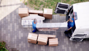 Workers load household goods into moving truck