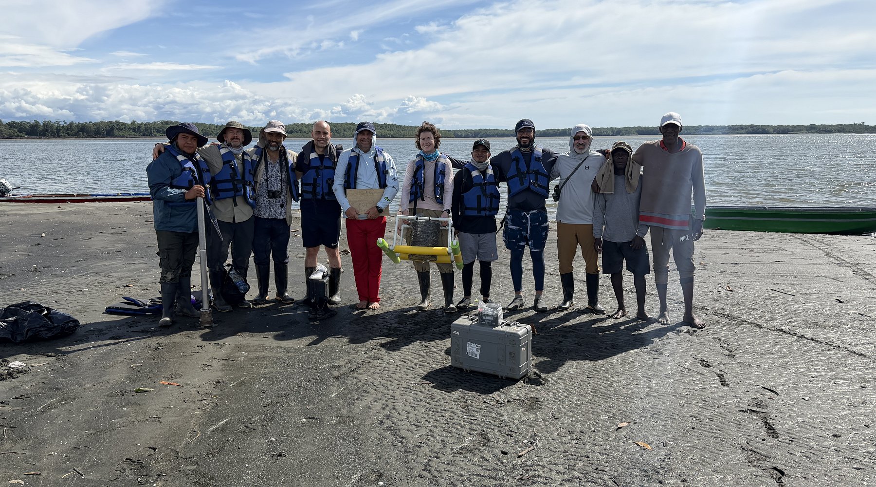 Research team of Cornell Faculty, students, and local experts gather on a beach in Colombia, while testing methane sensor