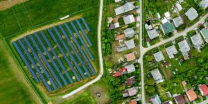 Aerial view of solar farm next to a neighborhood