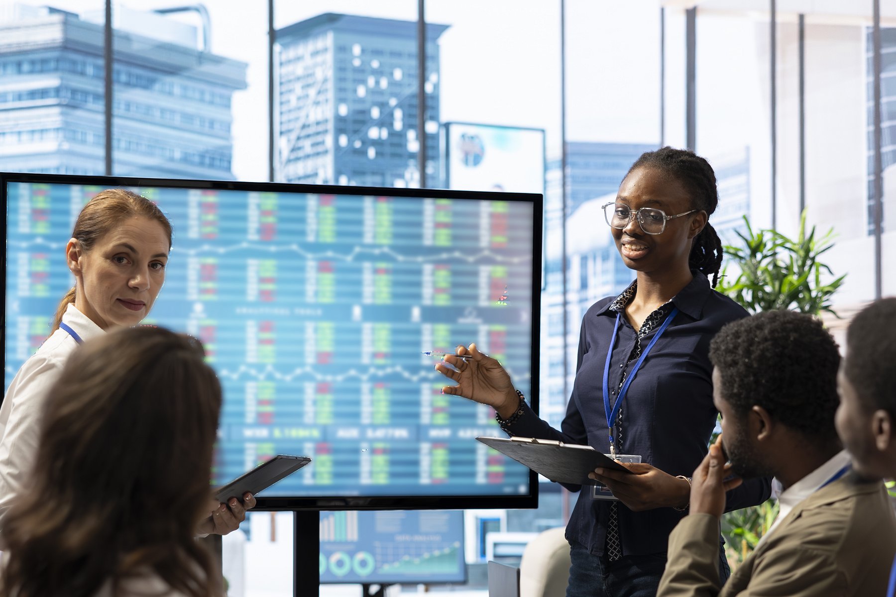 Researchers look at data on a large monitor (iStock)