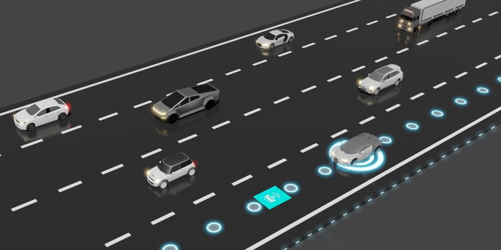 Illustration of electric car on highway with wireless charging station built into the road (iStock)
