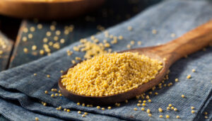 Wooden spoon holding millet
