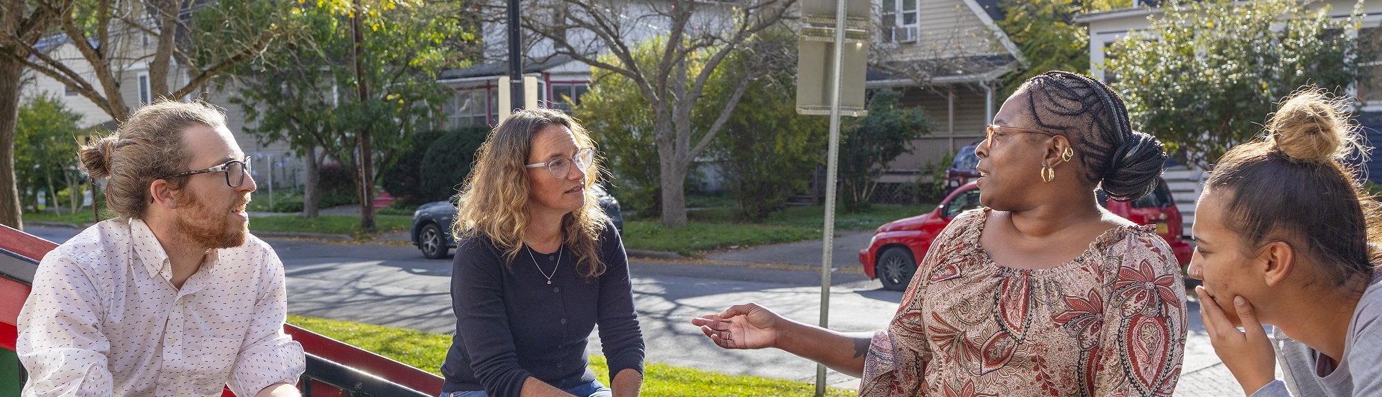 Alistair Hayden and Rebecca Morgenstern Brenner chat with Chavon Bunch, executive director of the Southside Community Center and Kayla Matos, deputy director of Southside Community Center, outside the Southside Community Center in Ithaca, New York. (Noël Heaney, UREL)