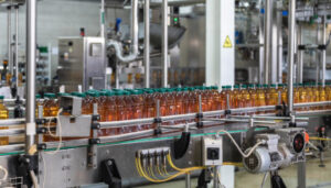 Photo of juice bottles on a conveyor belt in a processing plant